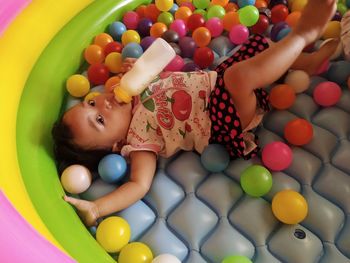 High angle view of baby boy lying in toys