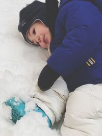 Cute boy lying on snow