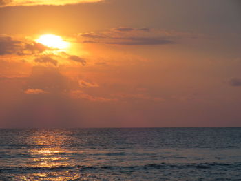 Scenic view of sea against orange sky