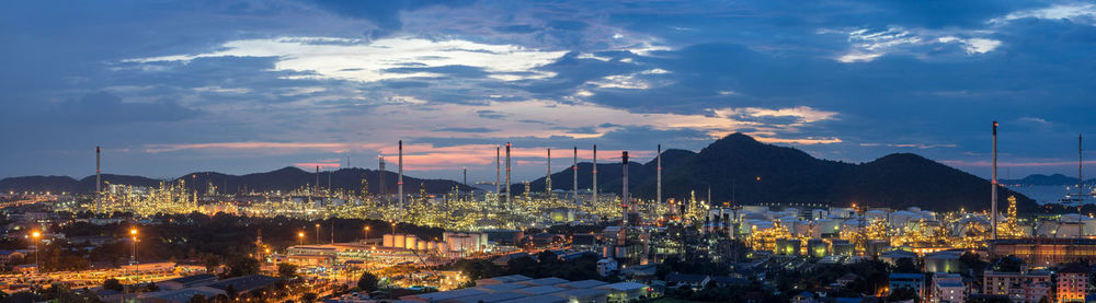 Panoramic view of illuminated buildings against sky at sunset