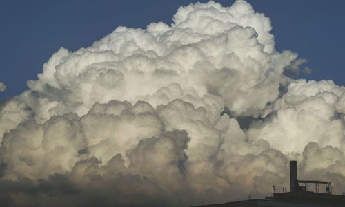 Smoke emitting from chimney against sky