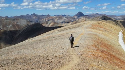 Full length of man on arid landscape against sky
