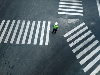 High angle view of man standing on crosswalk