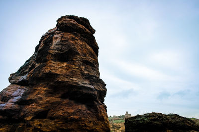 Low angle view of rock formations against sky