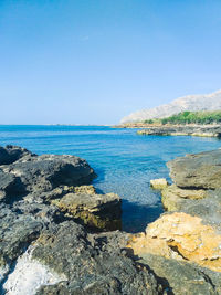 Scenic view of sea against clear blue sky