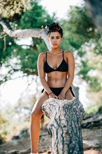 Portrait of young woman against tree