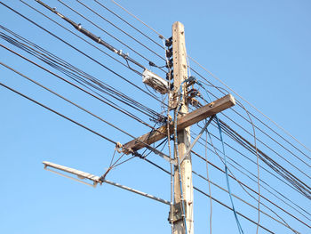 Low angle view of electricity pylon against sky