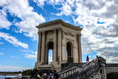 Low angle view of brandenburg gate against cloudy sky