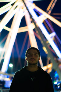 Full length portrait of young man standing at night