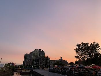 Silhouette buildings against sky during sunset