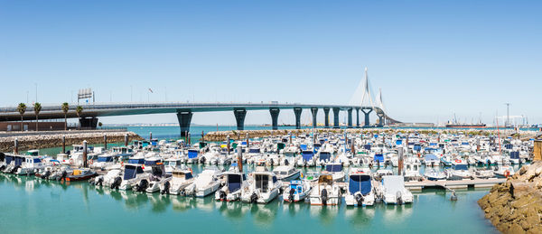 Boats in sea against clear sky