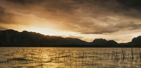 Scenic view of lake against sky during sunset