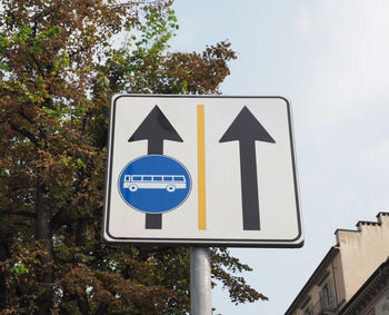 Low angle view of road sign against sky