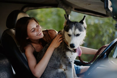 Portrait of young woman with dog