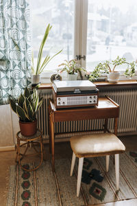 Audio equipment and plants arranged on table at home
