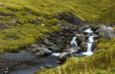 Scenic view of stream flowing through rocks