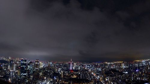 Illuminated cityscape against sky at night