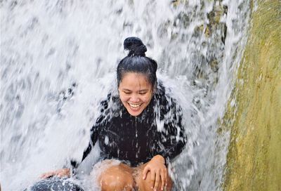 Low angle view of a woman in a splashing water
