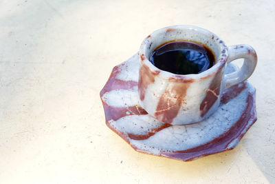 High angle view of coffee cup on table