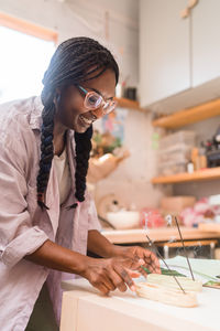 Woman with braided hair lighting up incense