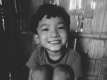 Portrait of smiling boy sitting at home