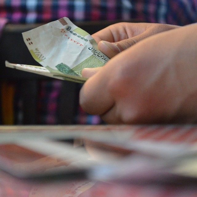 indoors, person, close-up, book, part of, selective focus, lifestyles, midsection, cropped, focus on foreground, holding, human finger, text, mid section, paper, writing