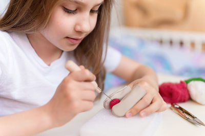 Felt wool craft handmade needle. little kid girl artisan hand makes creative toy made of sheep hair