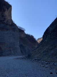 Scenic view of mountains against clear blue sky