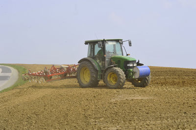 Tractor on field against sky