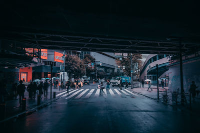 People walking on road in city at night