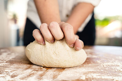 Close-up of person preparing food on table