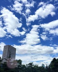 Low angle view of building against cloudy sky