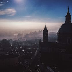 Buildings against cloudy sky