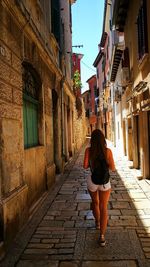 Rear view of woman walking on street