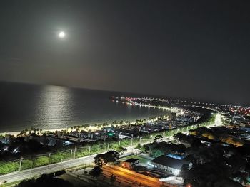 High angle view of illuminated city against sky at night