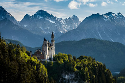 Panoramic view of trees and buildings against sky
