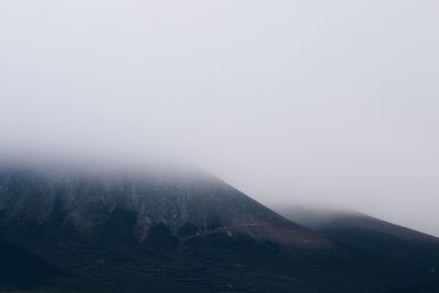 Scenic view of mountains against sky during winter