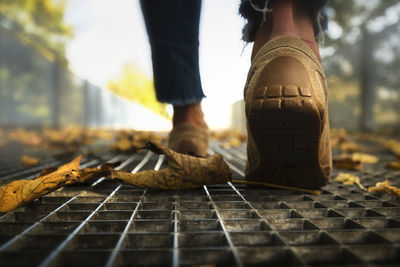 Low section of man standing on railroad track