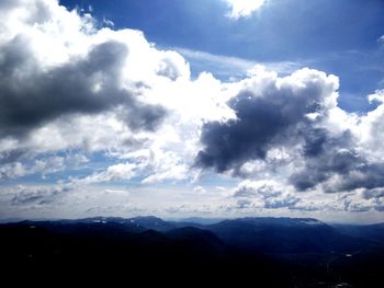 Scenic view of mountains against cloudy sky