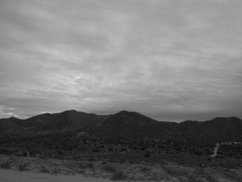 Scenic view of mountains against cloudy sky