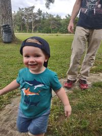 Full length of father and daughter on field
