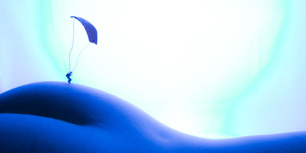 Close-up of butterfly against blue sky