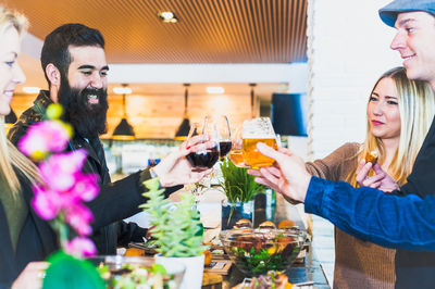 Friends toasting wineglass at table in bar