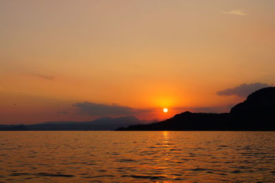 Scenic view of sea against romantic sky at sunset