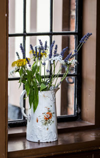Flower vase on window sill