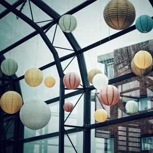 Low angle view of illuminated lanterns hanging at home