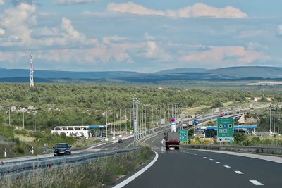 Cars on highway against sky