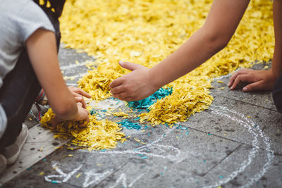 Close-up of children playing with confetti