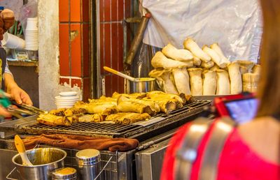 Man holding vegetables at market stall