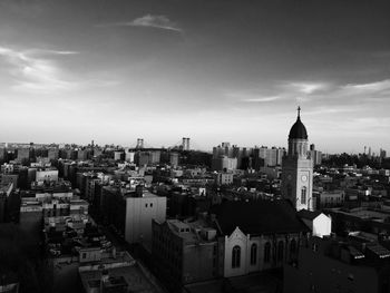 Cityscape against cloudy sky